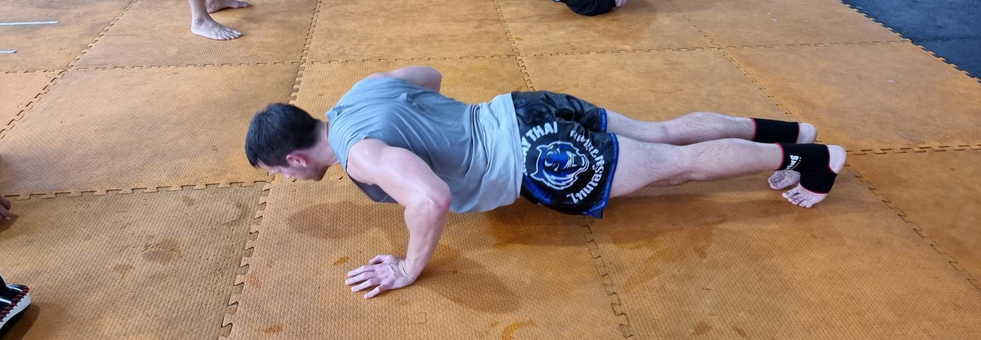 Stuart Wade performing a press up at Tiger Muay Thai in Phuket, Thailand