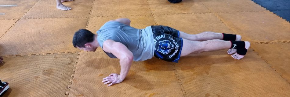 Stuart Wade performing a press up at Tiger Muay Thai in Phuket, Thailand